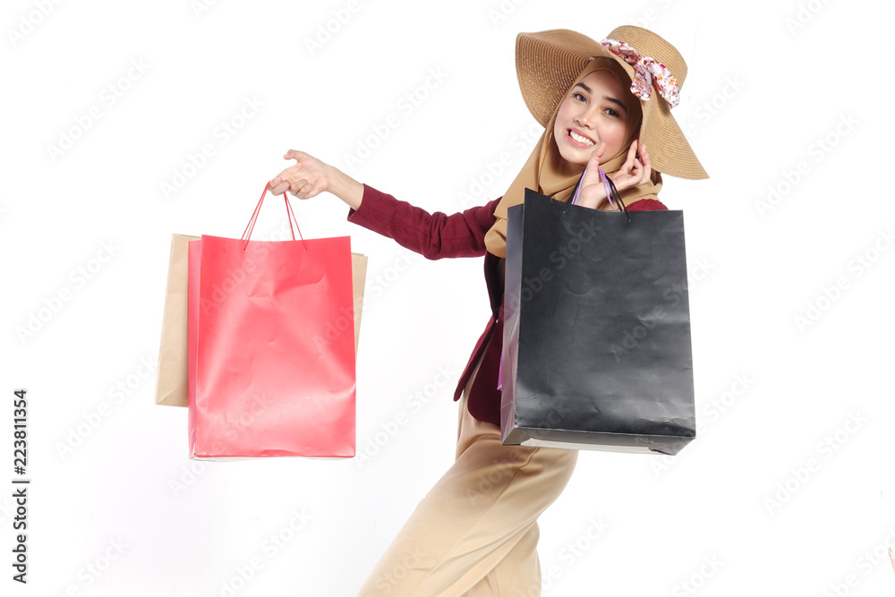 Portrait of a beautiful young muslim woman with shopping bags Portrait of a beautiful young muslim woman with shopping bags