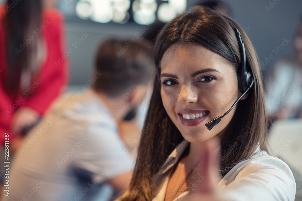 Customer Service agent in an startup office with laptop Customer Service agent in an startup office with laptop