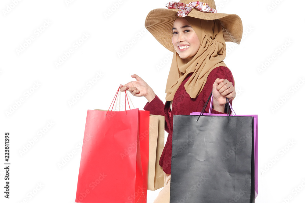 Portrait of a beautiful young muslim woman with shopping bags Portrait of a beautiful young muslim woman with shopping bags