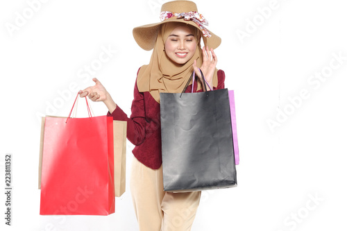 Portrait of a beautiful young muslim woman with shopping bags