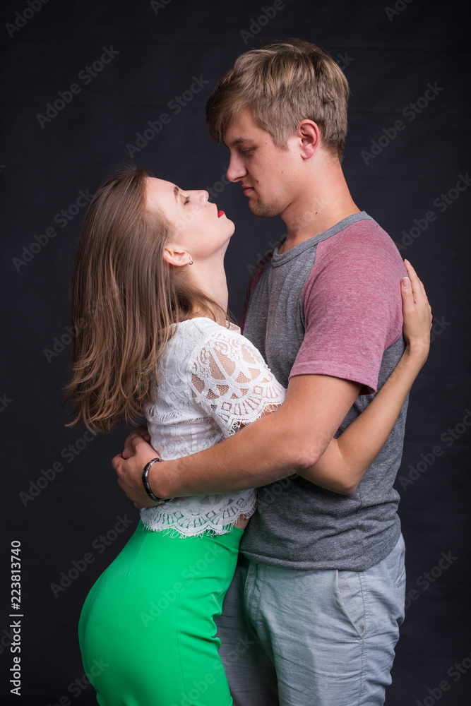 Passionate young people in love on black background Passionate young people in love on black background