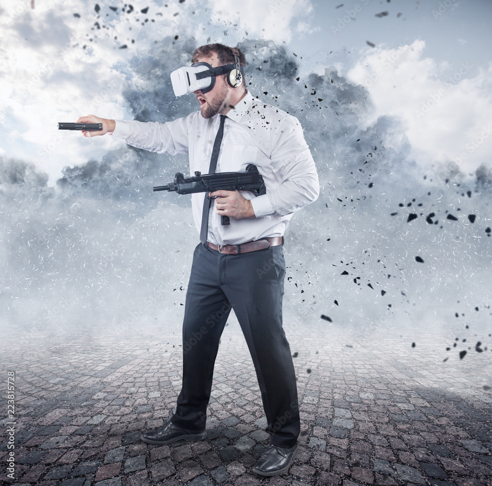 Naklejka premium Businessman is playing a game wearing virtual reality glasses and holding a gun
