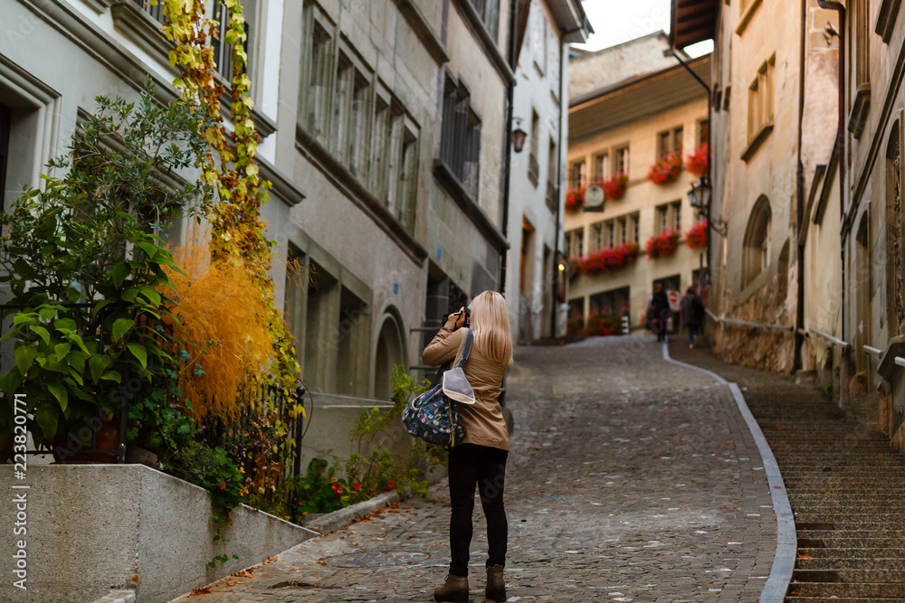 Beautiful girl photographer taking photos in Friburg, Switzerland