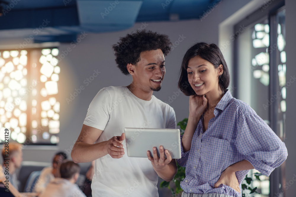 business, technology, startup and people concept - happy creative team with tablet pc computers in office