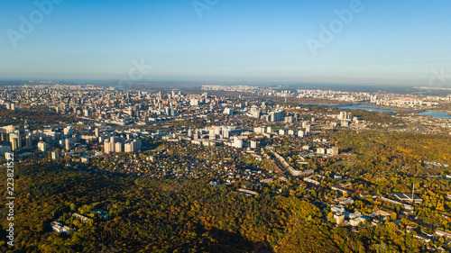 Fototapeta Naklejka Na Ścianę i Meble -  Golden autumn Kyiv cityscape, aerial drone view of city skyline and forest with yellow trees and beautiful landscape from above, Kiev, Goloseevo forest, Ukraine
