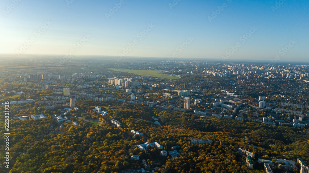 Golden autumn Kyiv cityscape, aerial drone view of city skyline and forest with yellow trees and beautiful landscape from above, Kiev, Goloseevo forest, Ukraine
