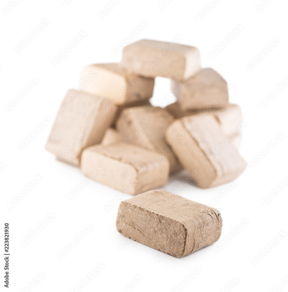 Wooden pressed briquettes from biomass on a white isolated background