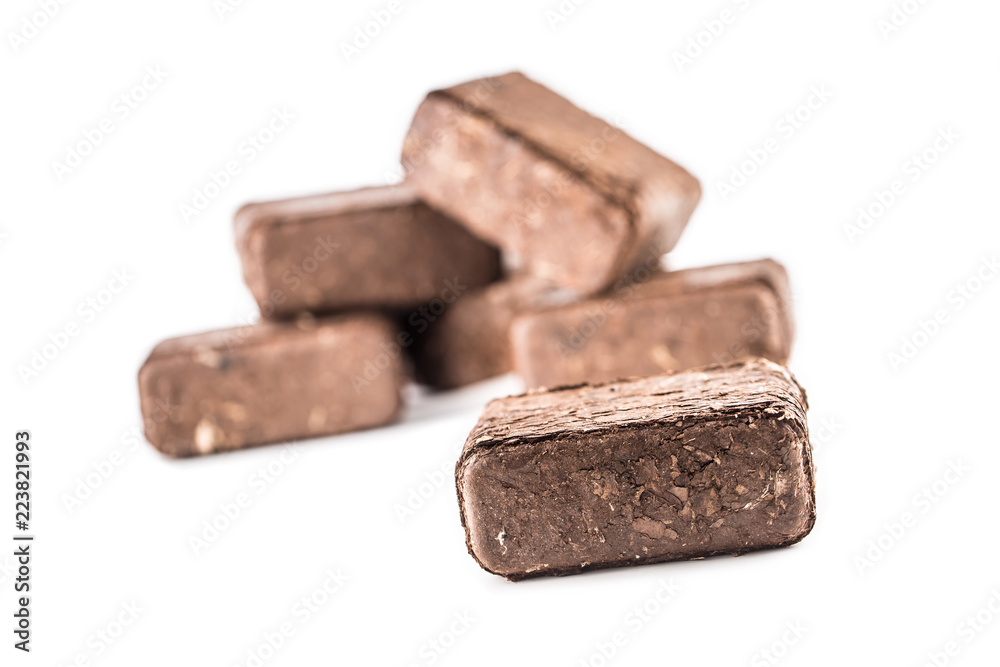 Wooden pressed briquettes from biomass on a white isolated backg Wooden pressed briquettes from biomass on a white isolated backg