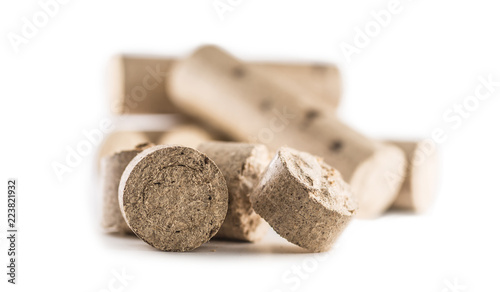Foto Wooden pressed briquettes from biomass on a white isolated background