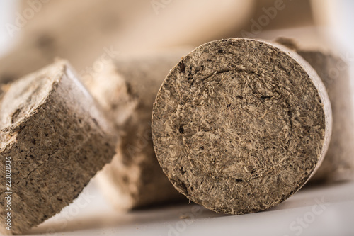 Close-up wooden pressed briquettes from biomass photo