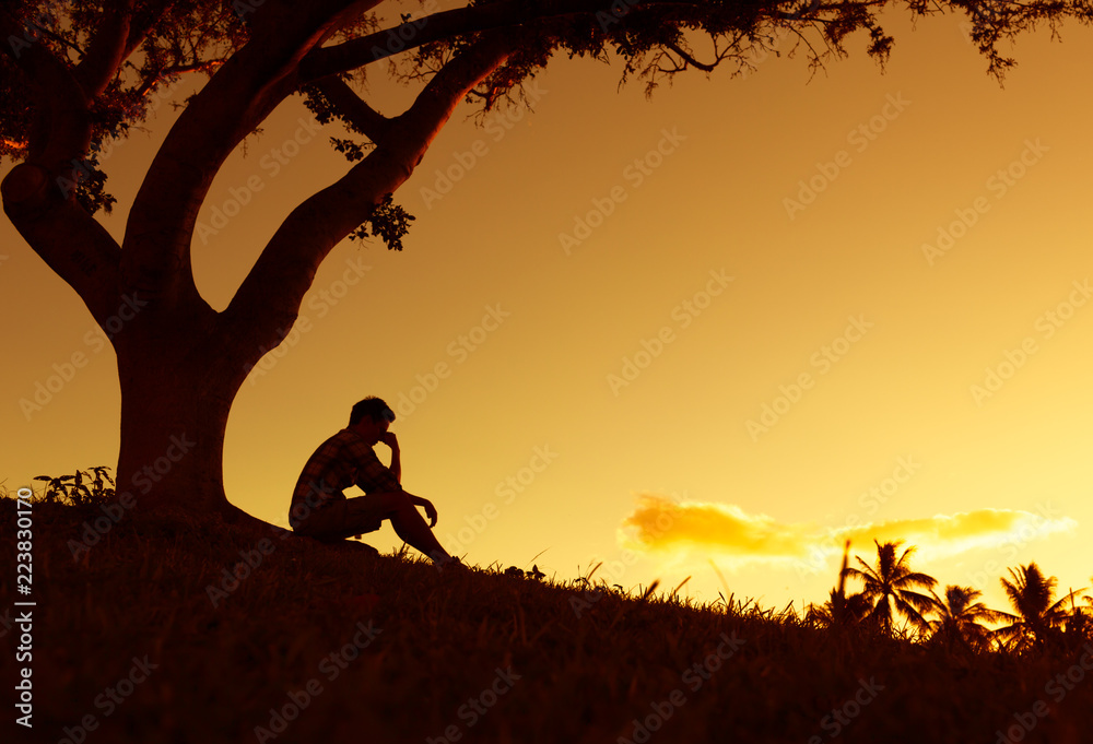 Sad lonely man sitting in the park. фотография Stock | Adobe Stock