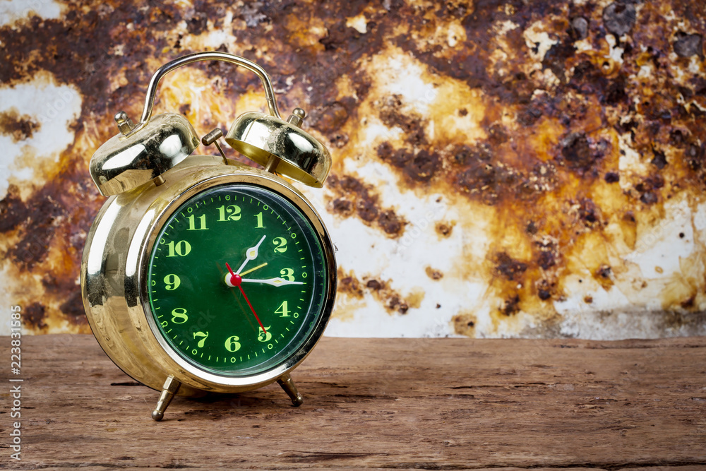 Retro alarm clock on wood table. select focus