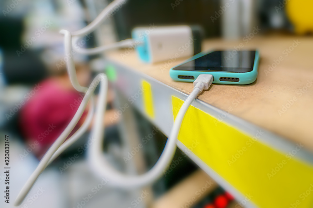 smartphone on the shelf is charged from the charger smartphone on the shelf is charged from the charger