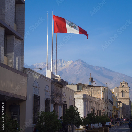 Flag of Peru in Arequipa with background of Chachani volcano