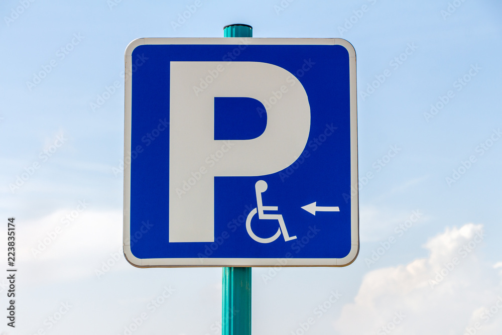 Blue disable parking vertical sign on blue sky Blue disable parking vertical sign on blue sky