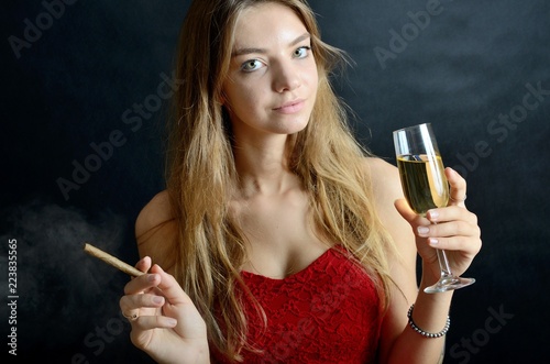 Young female with cigarillo and white wine photo