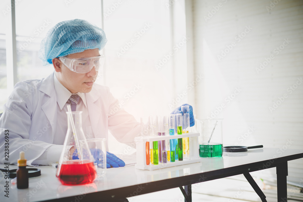 Senior scientist are examining the results with a test tube in a science lab. Researcher working in the laboratory. Senior scientist are examining the results with a test tube in a science lab. Researcher working in the laboratory.