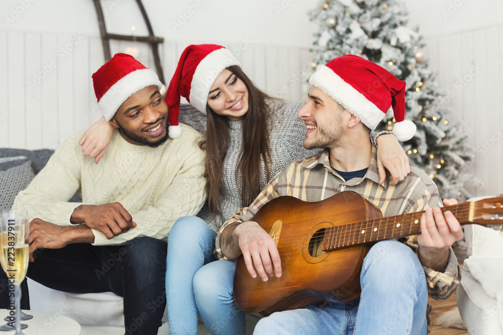 Happy friends celebrating Christmas together Happy friends celebrating Christmas together