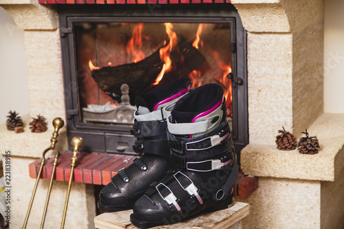 Boots ski boots in front of fireplace