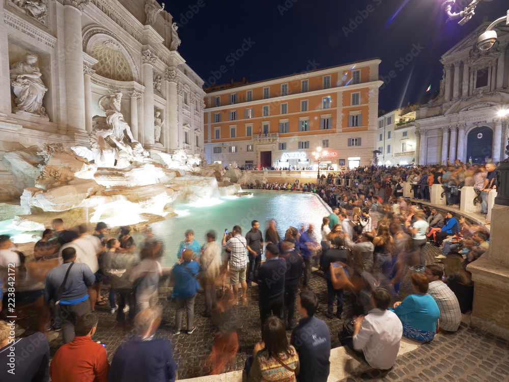 Mass tourism at famous sightseeing attraction Trevi fountain in Rome, Italy