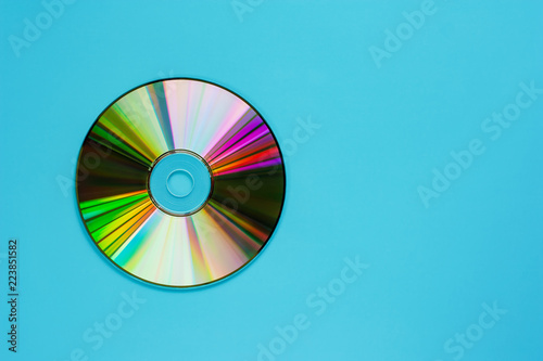 Compact disc (CD) on blue background for audio and data storage photo