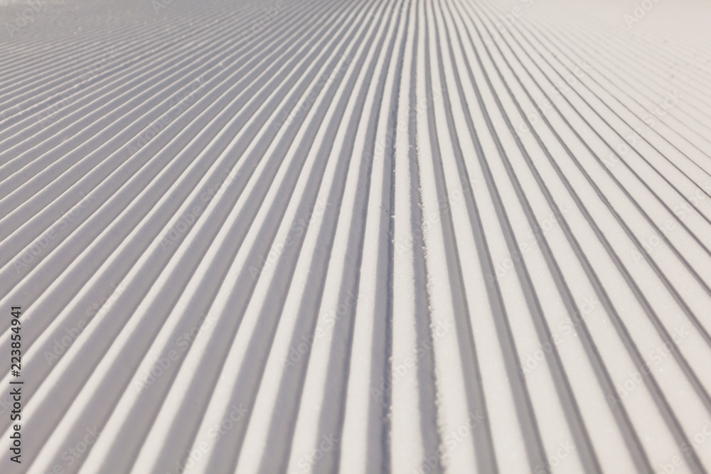 Texture of new groomed snow on empty ski slope Texture of new groomed snow on empty ski slope