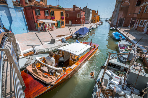 Fototapeta Naklejka Na Ścianę i Meble -  Historical architecture and landmarks in Venice old town in Italy. Narrow streets with colorful buildings surrounded by tourists. Beautiful scenery of romantic canals and boats.