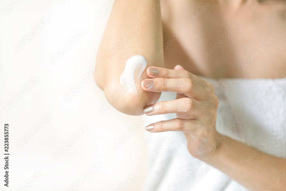 Woman applying elbow cream,lotion , Hygiene skin body care concept.