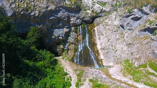 Aerial view: Rainbow colors from incredible waterfall in Cherkessky waterfall nature reserve Ritsa National Park. Gegsky waterfall and double rainbow in the mountains of Abkhazia, summer, day. photo