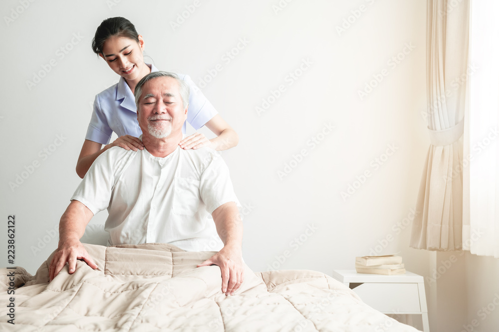 Fototapeta premium Young attractive physiotherapist working on senior man.