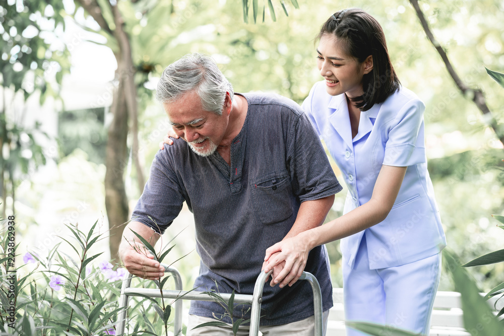 Nurse with patient using walker in retirement home. Nurse with patient using walker in retirement home.