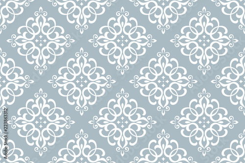 Floral pattern. Vintage wallpaper in the Baroque style. Seamless vector background. White and blue ornament for fabric, wallpaper, packaging. Ornate Damask flower ornament