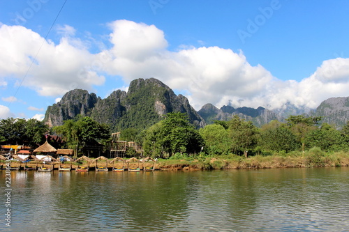 Fototapeta Naklejka Na Ścianę i Meble -  Vang Vieng, Laos - January 1, 2016 : Travel Song River, The river clear and  mountain view beautiful and blue sky