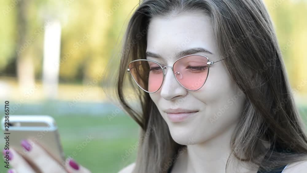 portrait of a beautiful young caucasian woman look in camera and reed message in phone portrait of a beautiful young caucasian woman look in camera and reed message in phone