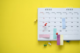 close up of calendar on the yellow background, planning for business meeting or travel planning concept
