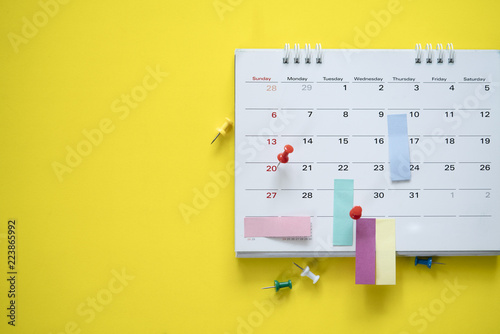 close up of calendar on the yellow background, planning for business meeting or travel planning concept photo