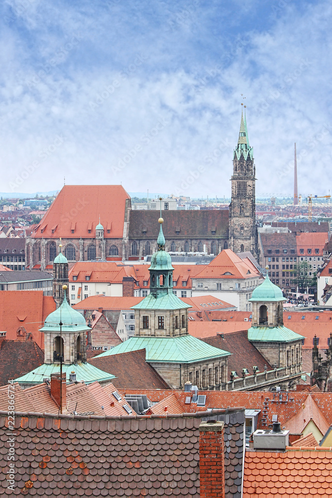 View over Nuremberg old town from the Kaiserburg, Franconia, Bavaria, Germany, with the spires of the Town Hall or Rathaus and St Lawrence church or Lorenzkirche.