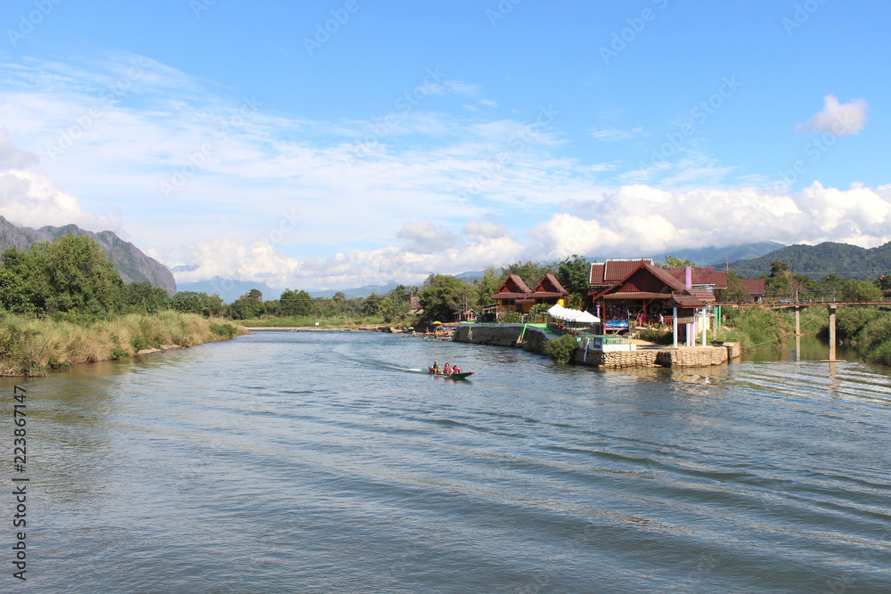 Fototapeta premium vang, vieng, landscape, tourism, river, destination, song, motorboat, karst, nam, laos, nature, people, water, travel, outdoor, traditional, tropical, asian, rock, rural, scenic, mountain, transportat