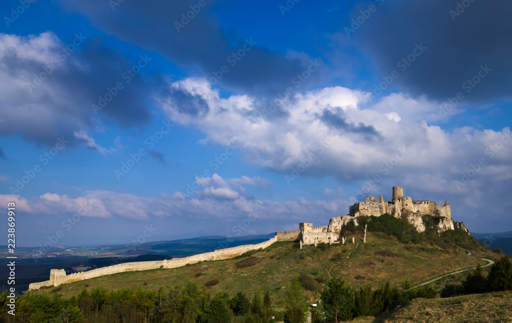 A southeastern view of the Spis castle in the morning in early spring with dramatic cloudy sky