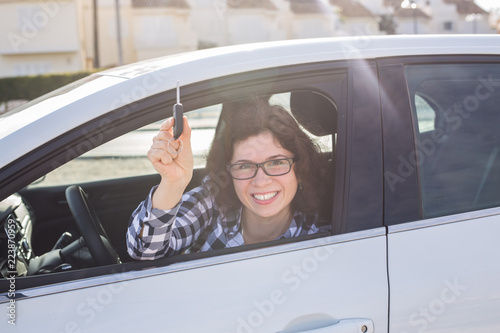 New car, purchase and driver concept - Attractive happy woman shows keys from the new car © satura_