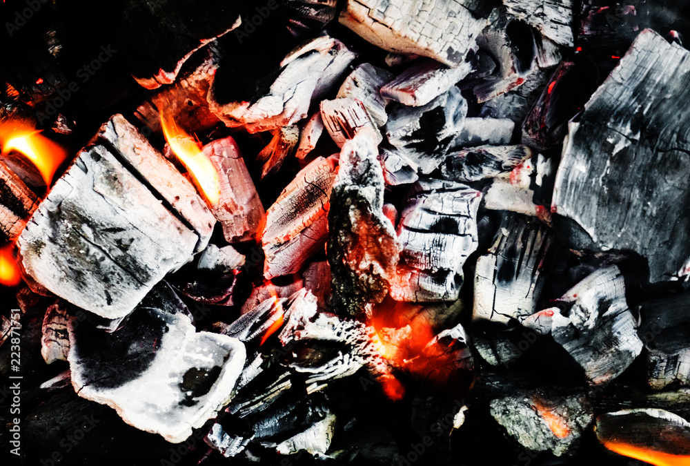 Smoldering embers of fire, live coals, burning charcoal in the background texture, closeup, glowing coal Smoldering embers of fire, live coals, burning charcoal in the background texture, closeup, glowing coal
