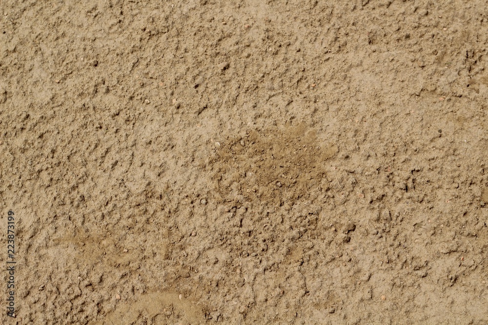 A close up view of the dirt on the ground surface texture of a baseball diamond. A close up view of the dirt on the ground surface texture of a baseball diamond.