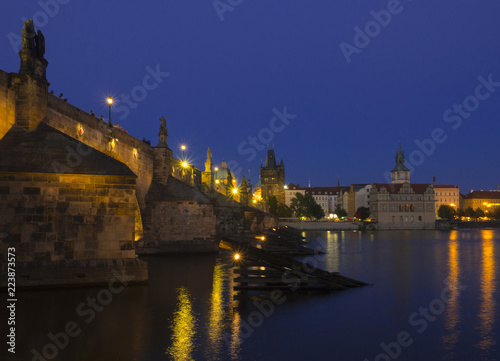 View of iluminated Charles Bridge in from Kampa  Czech Republic. Gothic Charles Bridge is one of the most visited sights in Prague. Architecture and landmark of Prague  night blue hour after sunset