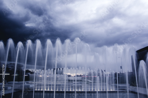Fantasy view of fountains and dark blue cloudy sky. Zagreb  Croatia.