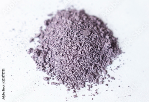 Natural colored pigment powder close up, matt pastel lilac eyeshadow or powder mica pigment on a white background photo