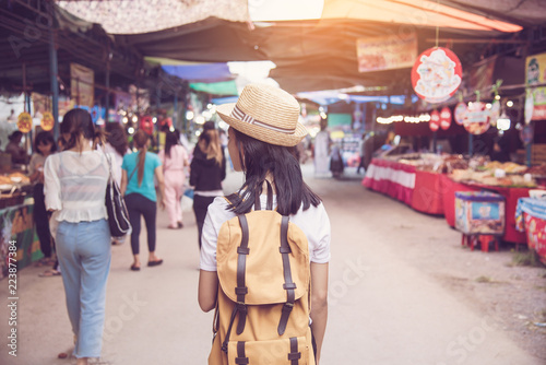 Teenagers backpacking along the market with many tourists - concept lifestyle