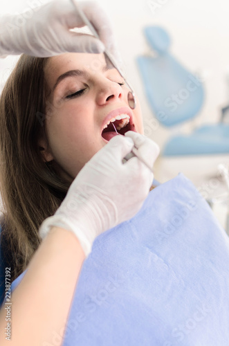 Fototapeta Naklejka Na Ścianę i Meble -  Dentist looking at a patient's teeth