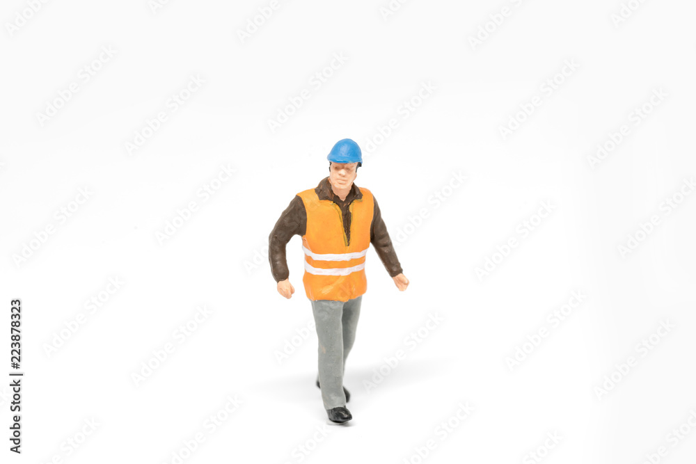 Miniature people worker safety construction concept on white background with a space for text