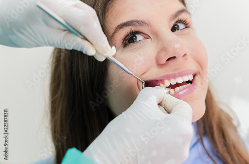 Fototapeta Naklejka Na Ścianę i Meble -  Young patient holdin gauze in mouth at dentist