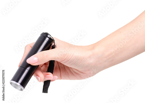 Black flashlight in hand on white background isolation